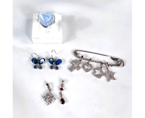 A modern ring with heart-shaped high relief pale blue stone, stamped S925; a pair of blue stone set butterfly earrings, diama