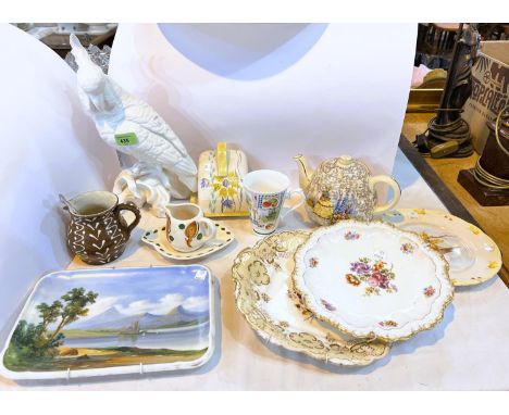 Four hand painted plates and a ceramic parrot.