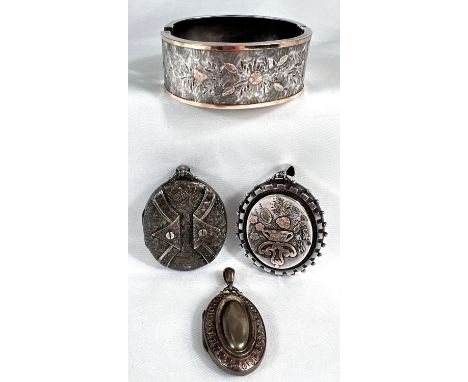 A silver stiff hinged bangle with applied gold decoration, Birmingham 1918 and 3 similar period silver lockets, 74gm.