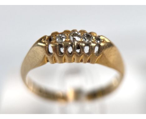 A lady's 18ct gold dress ring set with four (of five) graduating diamonds. 2.9grams.