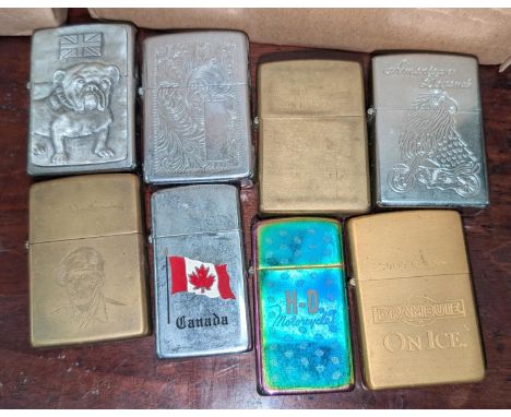 Eight Zippo lighters, various designs.