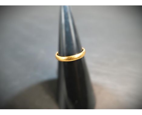 A 22 carat hallmarked gold wedding ring, 4.2 gms, size 'P'.