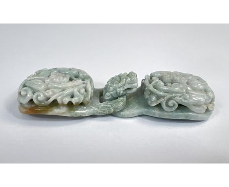 A Chinese ornately carved and pierced jade coloured buckle, overall length 13cm.