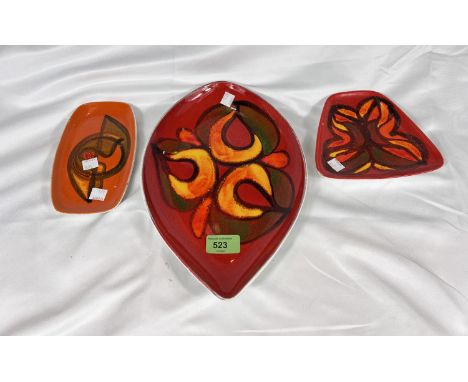 Three 1970's Poole pottery dishes in orange and red.