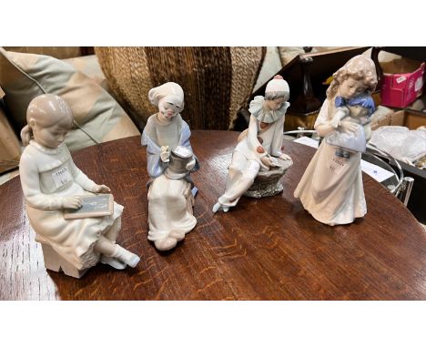 Four Nao figures of children:- two clowns and girls with slate and girl with doll.