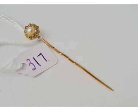 A pretty pearl and diamond cluster stick pin set in high carat gold