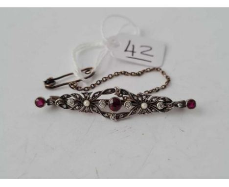 A Victorian ruby and diamond and pearl brooch set in silver and gold 