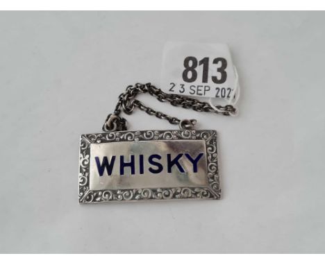 A silver and enamel decorated whiskey label 