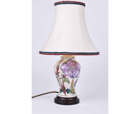 A Moorcroft lamp with lilac blue flowers to an ivory ground, marked in gold to the blue felt base 39.5 cm H inc. shade