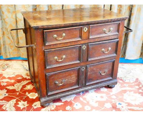 A Georgian oak chest of three graduated drawers with panel sides and applied wrought iron rails 86cm H