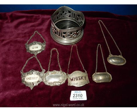 A plated bottle coaster and various decanter labels.