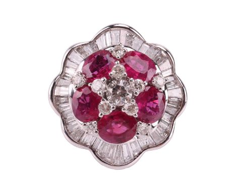 A ruby and diamond ballerina ring the central brilliant-cut diamond cluster highlighted by six oval-cut rubies, within an und