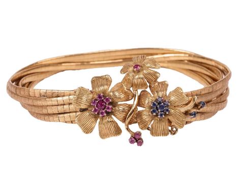 A gem-set floral upper arm bracelet, comprising seven strands of brush-finished links, to a flowerhead clasp set with cluster