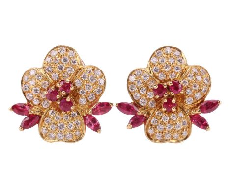 A pair of ruby and diamond floral earrings, each flowerhead pavé-set with round brilliant-cut diamonds, further adorned with 