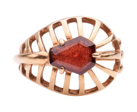 A garnet-set dress ring, set with a shield-shaped step-cut garnet in collet, to a domed wire ring head adjoined to a shank, s