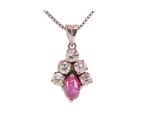 A star ruby and diamond-set cluster pendant, comprising a cabochon ruby measuring approximately 6.5mm x 4.5mm, surmounted by 