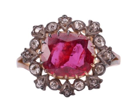 A ruby and diamond cluster ring, centred with an oval-cut ruby of 9.5 x 8.2 x 3.3 mm, within a frame of old-cut diamonds in f