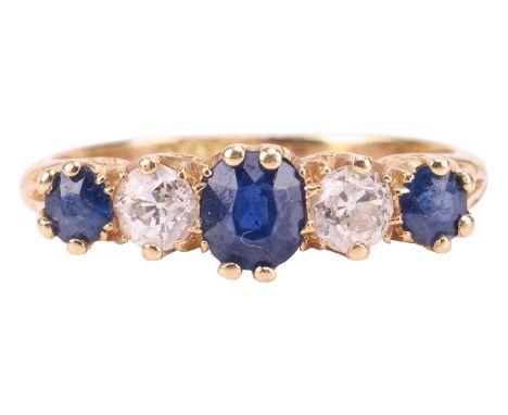 An Edwardian sapphire and diamond half-hoop ring in 18ct gold, comprising three graduated circular-cut sapphires, flanking tw