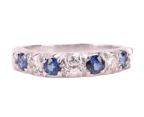 A sapphire and diamond half-eternity ring in 18ct white gold, comprising four circular-cut sapphires, alternating with brilli