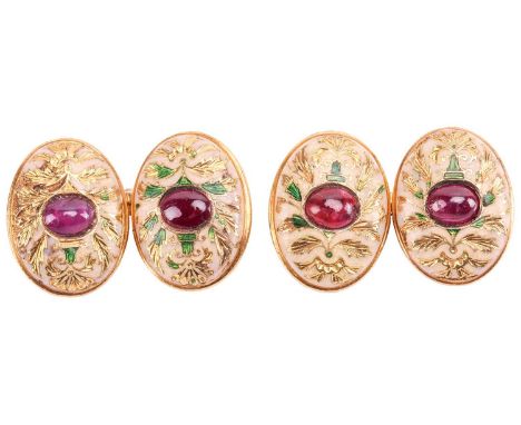 A pair of Edwardian ruby-set enamel cufflinks, each oval panel centred with an oval ruby cabochon, emanating with green ename