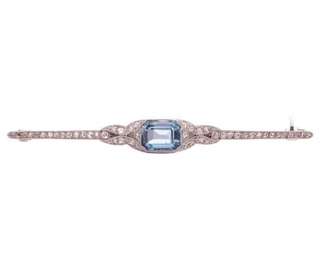 An early 20th-century aquamarine and diamond bar brooch, featuring a step-cut aquamarine with canted corners of deep blue col