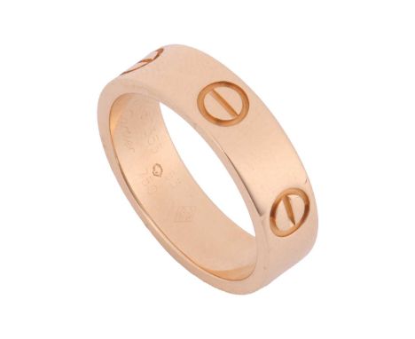 Cartier - a 'Love' ring, flat polished band decorated with screw-head motifs, signed and numbered, struck with Swiss assay ma