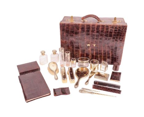 A fitted crocodile case with silver gilt travelling accoutrements by Drew and Sons of Picadilly. The interior is fitted with 