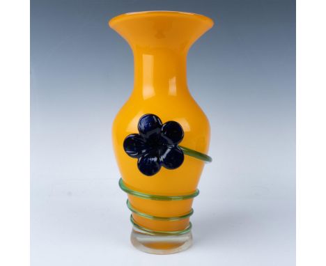A stunning vintage vessel crafted from orange blown glass, adorned with light green glass trailing and finished with a bold d