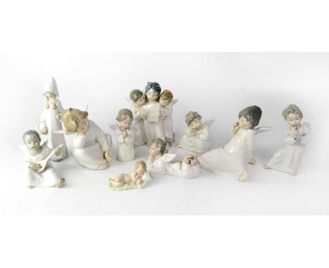 A group of ten figures, to include angelic choir group, two seated children with wings, a young girl in cloak and a sleeping 