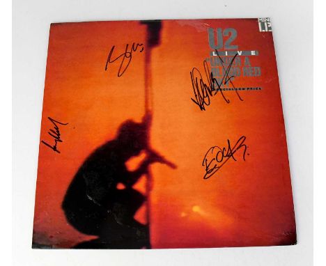 U2; LP 'Under A Blood Red Sky' bearing the signatures of the band to the front, Bono, Edge, Larry Mullen, and Adam Clayton.Co
