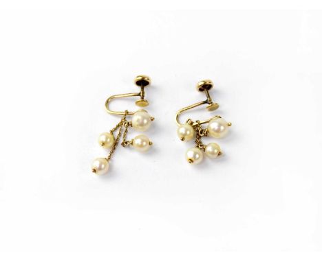 A pair of 14ct yellow gold screw back earrings, each with a single pearl with three pearls suspended by fine chain links, com
