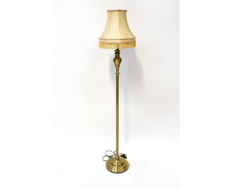 A contemporary brushed yellow metal standard lamp to circular spreading base, height 118cm.