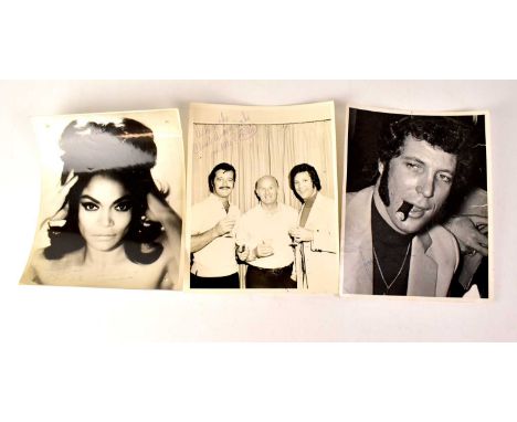 TOM JONES; a black and white portrait photograph, bearing signature, inscribed verso ‘To Jacqueline from Rocky, Tom's Bodygua
