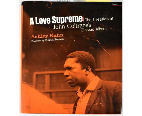 JOHN COLTRANE; 'A Love Supreme' by Ashley Kahn, bearing the signatures of Elvin Jones, McCoy Turner, Roy Haynes, Charlie Watt