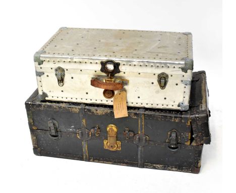 An early 20th century fitted travel trunk with dark blue exterior and metal bindings, locks and leather carrying handle (af) 