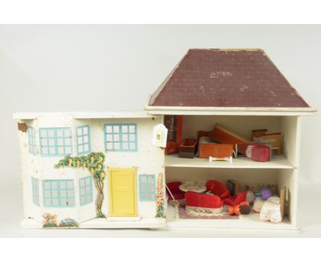 A vintage small dolls house, wood constructed with tin plate sliding front, includes a selection of furniture, approx 40cm hi