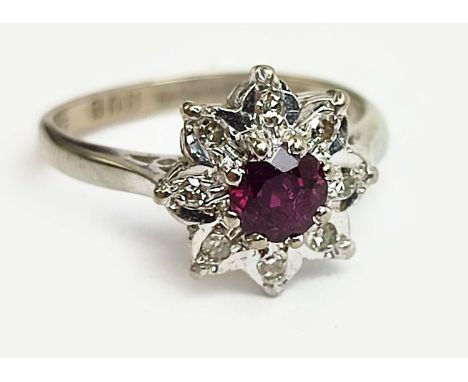 AN 18CT WHITE GOLD RUBY AND DIAMOND DRESS RING, flower head setting, the central ruby of approximately 0.33ct, the diamonds i