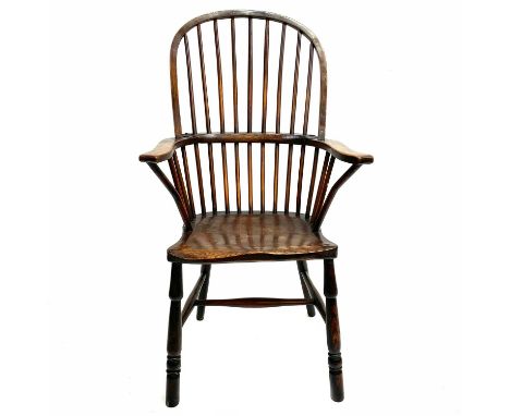 An ash, beech and elm Windsor armchair. 19th century, with stick back and figured broad arms, on turned legs, height 113cm, w