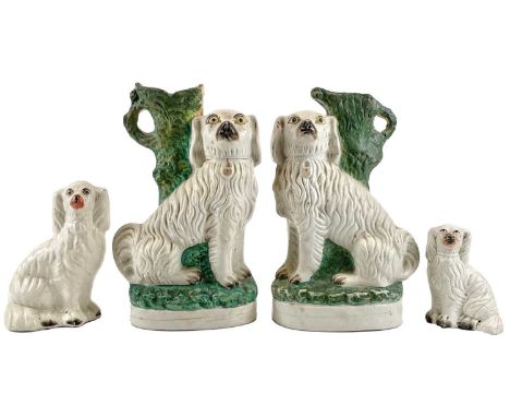 A pair of 19th century Staffordshire pottery spaniel spill vases. Height 30cm, together with two Staffordshire pottery models