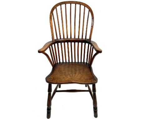 An ash and elm Windsor armchair. 19th century, with stick back and figured seat on turned legs, height 112cm, width 61.5cm, d