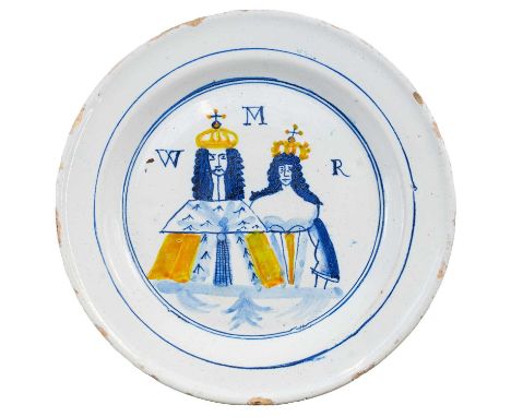 An English commemorative Delft plate. Circa 1690, polychrome painted with William and Mary and inscribed W M R, diameter 22cm