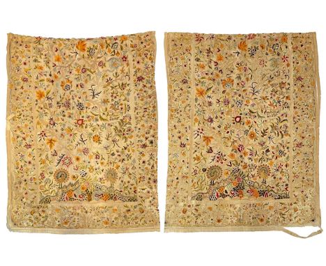 A pair of crewelwork fabric panels adapted into curtains.  The wool chain stitch decoration depicts a pair of peacocks in amo
