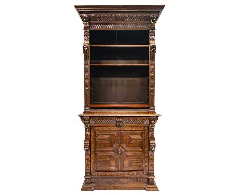 A Victorian oak bookcase cabinet. The upper part with open adjustable shelves with lion mask ring mounts and caryatid figures