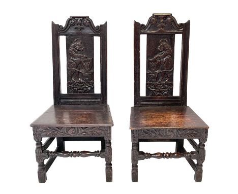 A pair of Welsh oak side chairs, probably Elizabethan, Each with a solid rectangular splat carved with a stylised standing bu