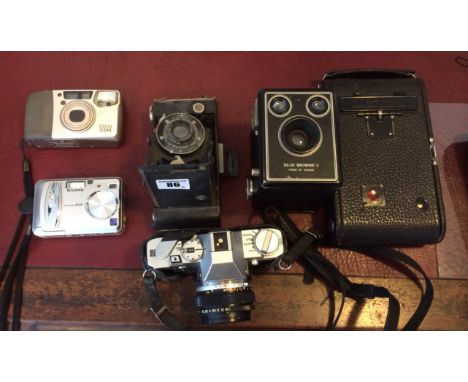 A Collection of 5 various cameras Olympus black case: H9cm W15cm L9cm Autographic film canister H11.5cm W10cm L7.5cm Kodak Br