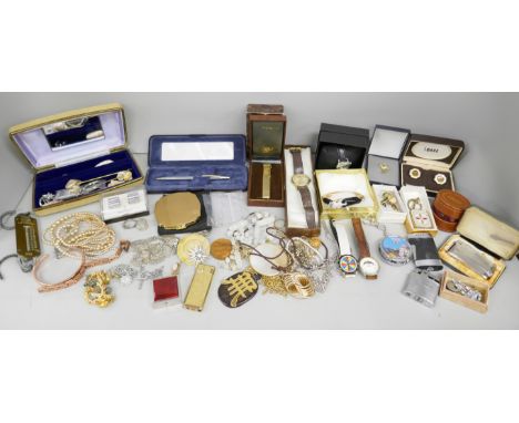 A box of mixed jewellery, lighters, wristwatches, pens including stone set brooches, bangle and pin badge *This lot is not av