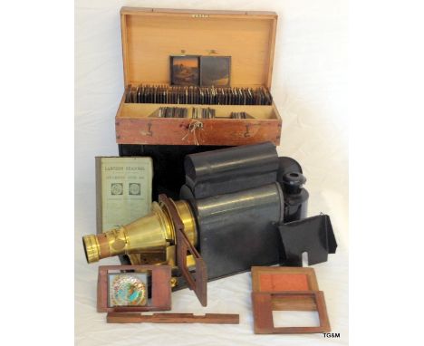 A late 1800's Magic Lantern projector with original case and handbook to include a mahogany boxed set of approx 100 slides