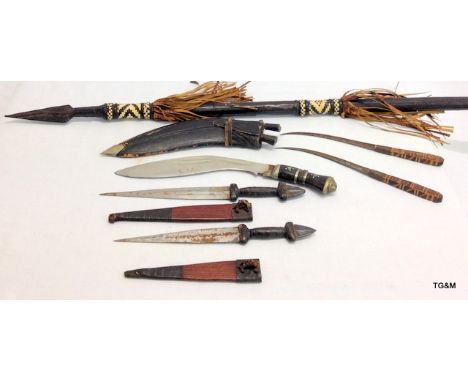 An Ethnic spear 41 inches long with 4 ethnic daggers and a kukri in its scabbard with sharpening knives