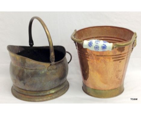 A hand beaten copper bucket with brass binding and ceramic handle and a brass helmet coal scuttle