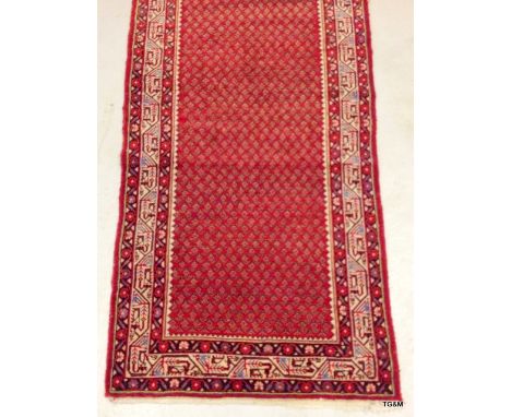 A quality 'Tabriz' rug with repeated design in light red and cream borders 318 x 113